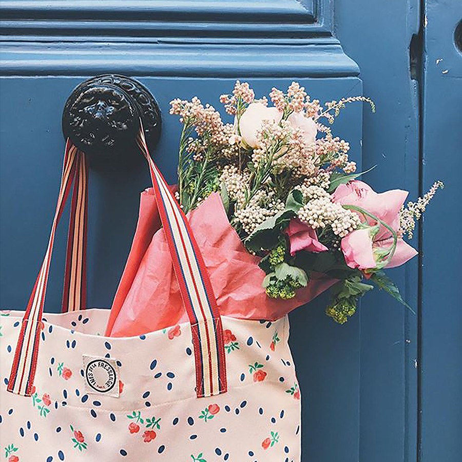 Ines de la Fressange featured image flowers in pink bag on door handle