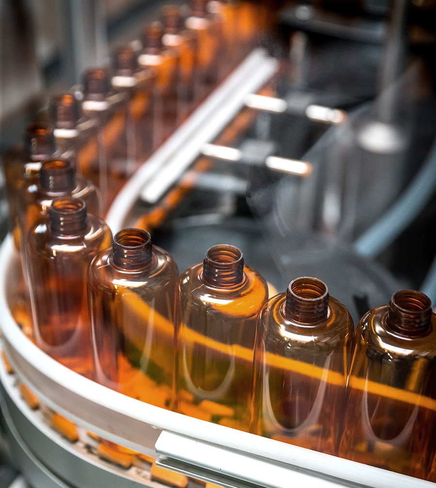 soap bottles in factory on conveyor belt