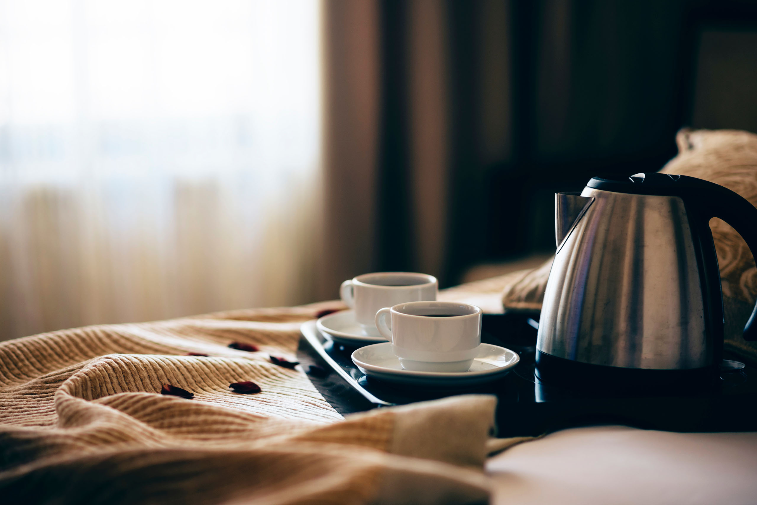 Morning breakfast with black coffee in bedroom.